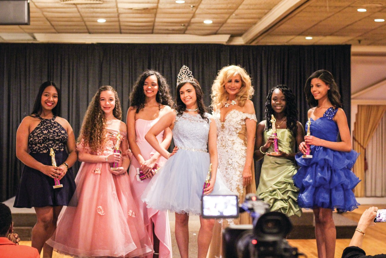 PAGEANT EXPERIENCE: Isabella James Indellicati, third from left, shares a moment with girls 11-14 winner Lily Addonizio, center, of Cranston and other contestants following the “A Touch of Royalty Pageant” held in Swansea in 2019.